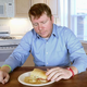 Illustration for article titled Man Takes Sober Moment To Reflect On Fact That Most Of Meal Already Gone